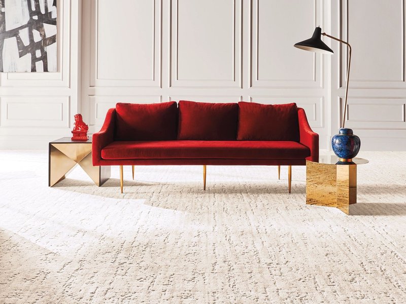 Red sofa on the carpet from Galbraiths Inc. Flooring in Carthage, MO